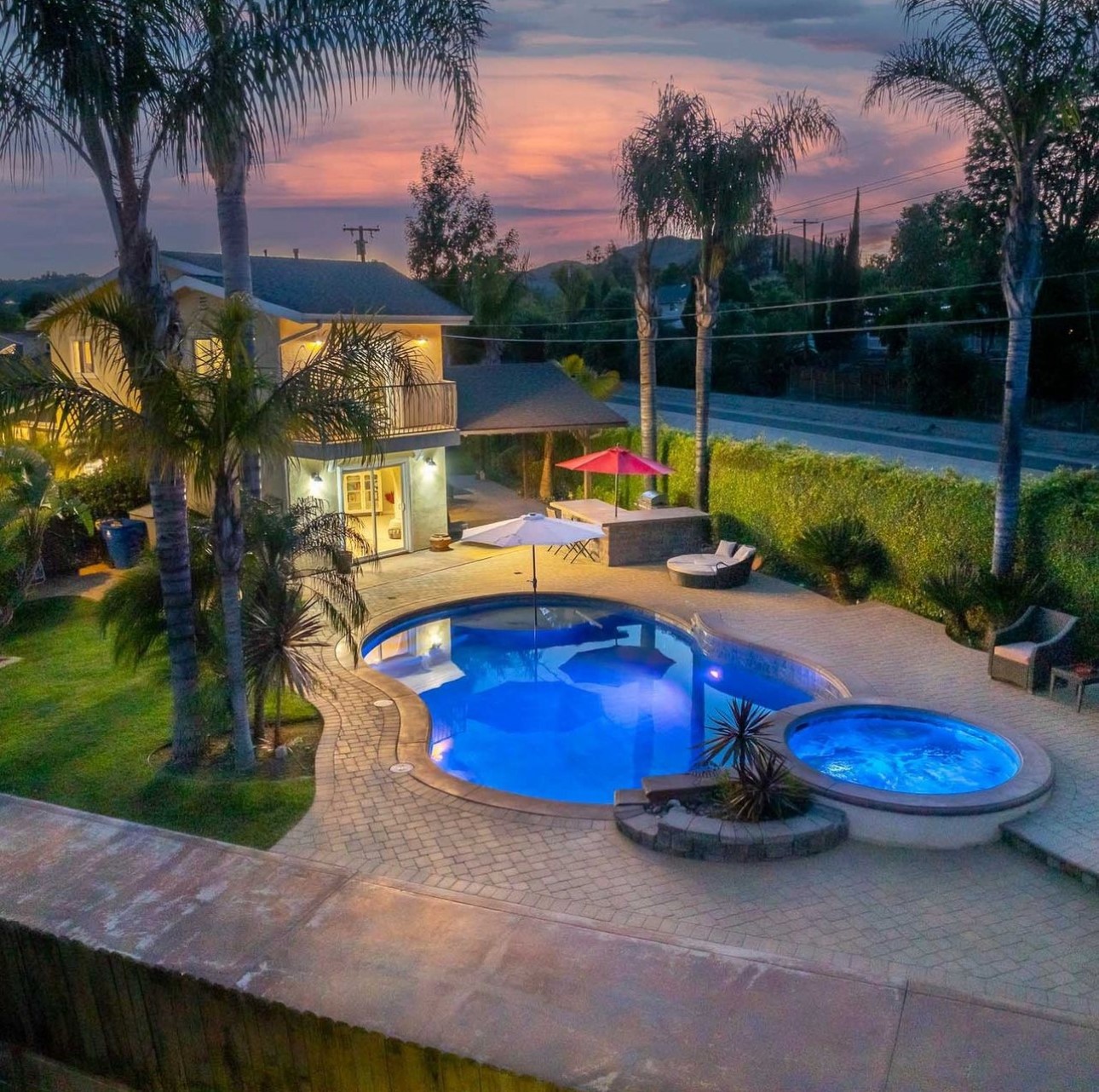 A pool with two jacuzzi jets and a palm tree.