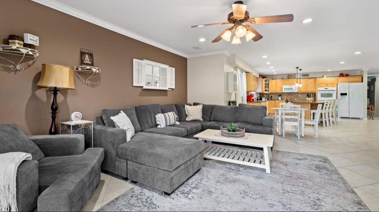 A living room with gray couches and a white coffee table.