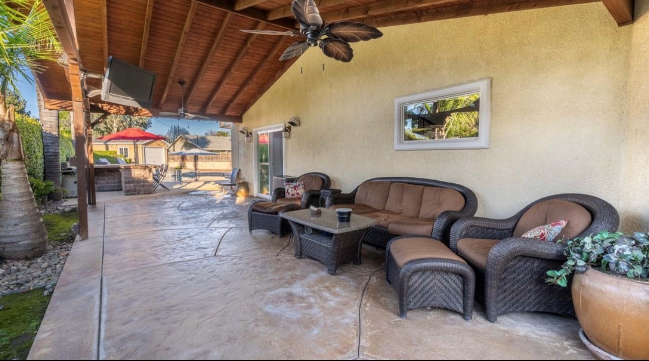 A patio with furniture and a table in it