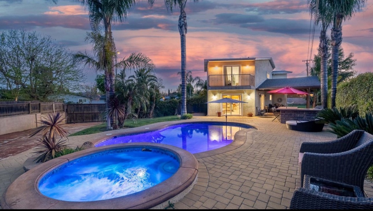 A pool and hot tub in the middle of an outdoor area.